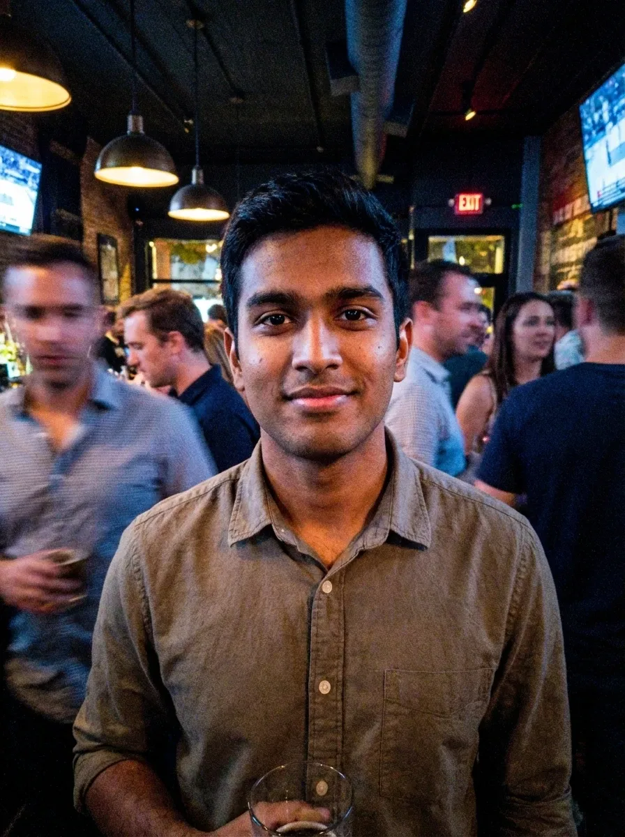 Original selfie input — young man in a beige shirt at an indoor event